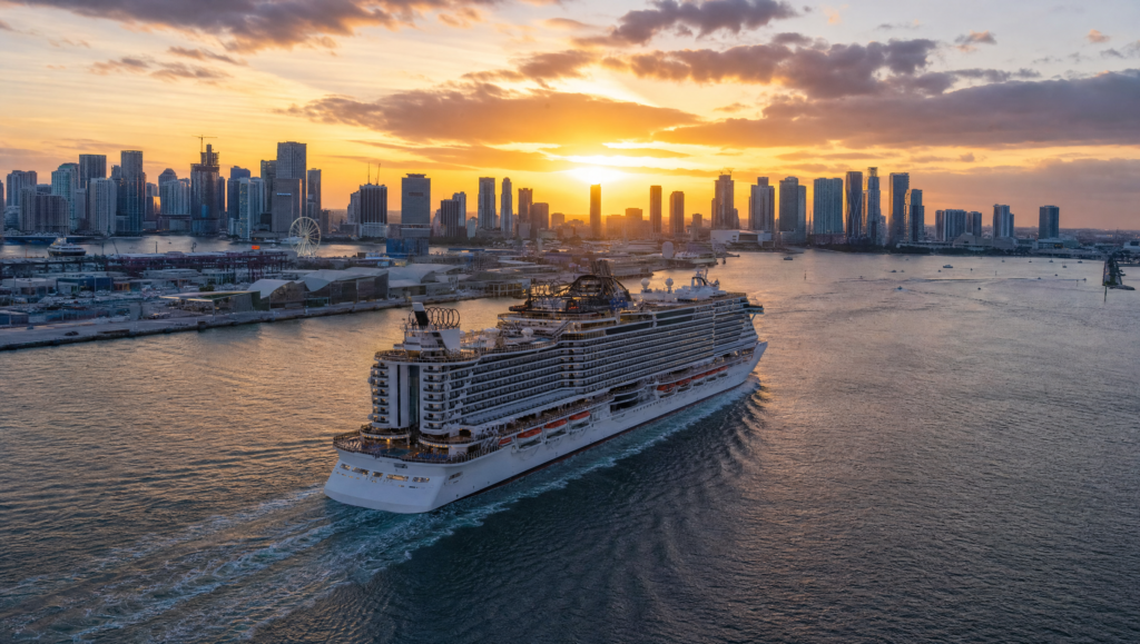 Cruise ship departing PortMiami with the Miami skyline at dusk